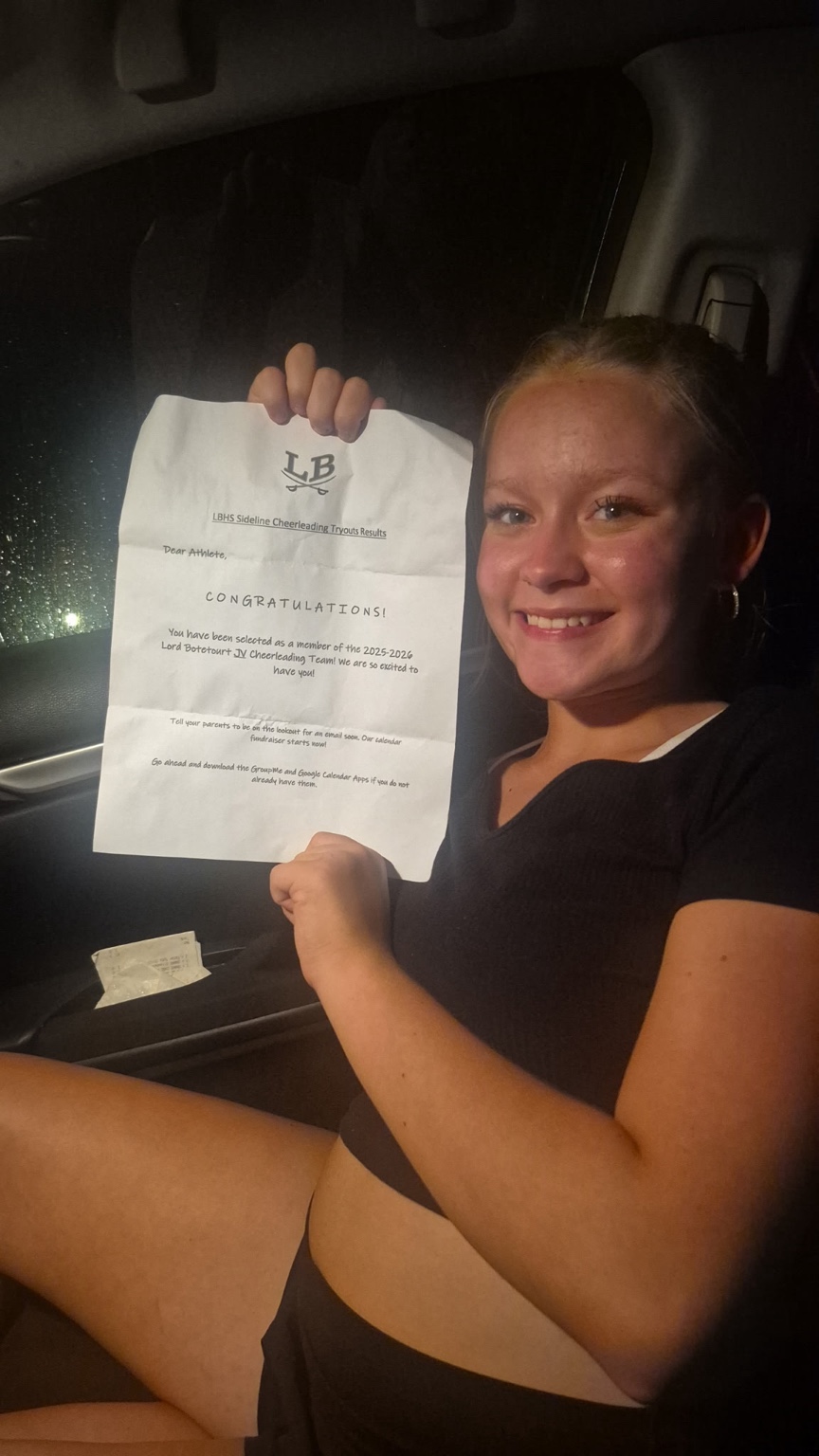 Phenix Tyree smiling with her cheer acceptance letter